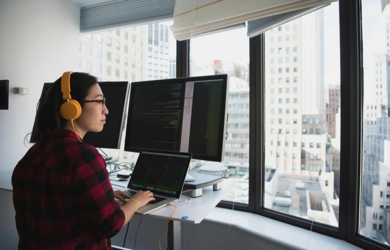 Technical support specialist reviewing mobile app performance metrics